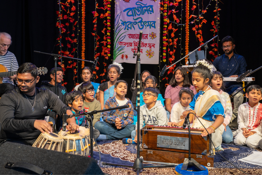 Student performing Indian classical music on stage in Berlin